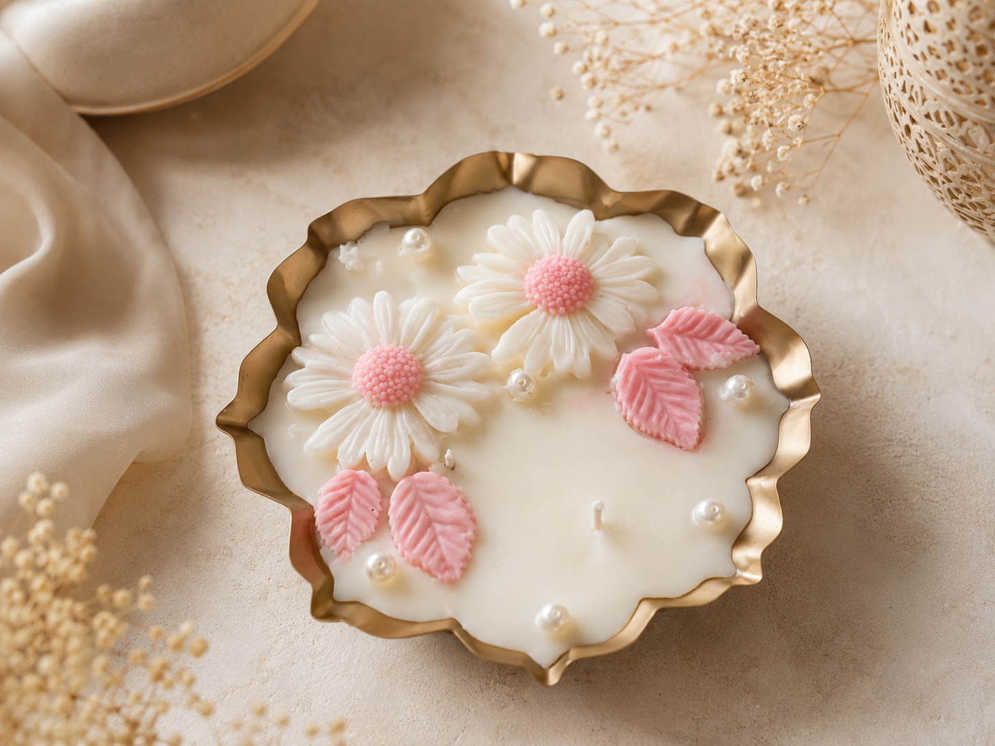 Itrāa Essence Blush Bloom Urli Candle, 6.5-inch decorative candle with a soft blush pink design and floral accents.